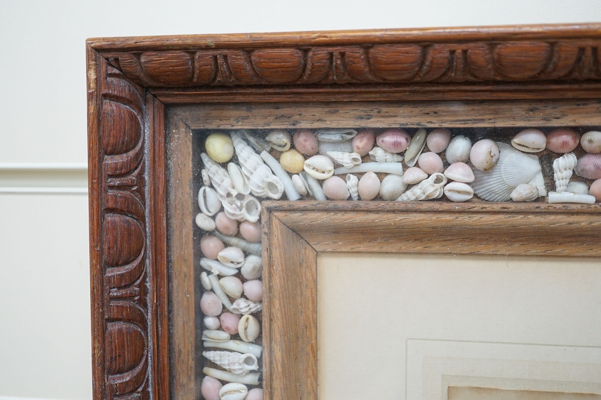 An oak and coloured shell picture frame, 49 x 53cm.